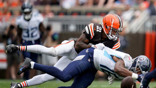 Cleveland Browns cornerback Denzel Ward (21) breaks up a pass intended for Tennessee Titans wide receiver Treylon Burks (16) during the second quarter in Cleveland, Ohio, Sunday, Sept. 24, 2023.